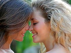 Two beautiful girls are making love outside