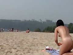 Beautiful fresh faced teen plays at the beach nude