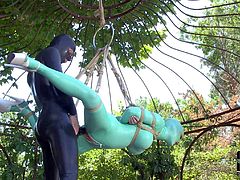 Latex Lucy is helpless outdoors in suspension bondage. She gets her mouth and vagina fucked by mistress in rubber outfit. Watch her get strapon fucked with no mercy in the garden.