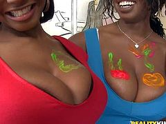 Baby Cakes and Delotta are juicy black women with gigantic natural tits. They go topless and then get their massive melons painted by curious white guy. He loves their huge boobies.