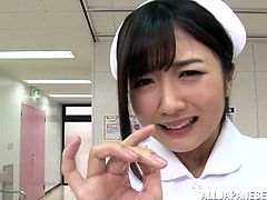 Cute Japanese girl in nurse uniform drops to her knees and gives a blowjob to a patient in POV video. She also pleases his dick with her soft hands.