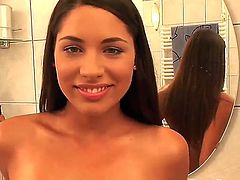 Beautiful young brunette Zafira has got filmed in the bathroom she is sitting on toilet nude and showing her shaved pussy pissing.