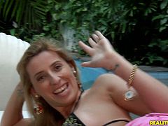 Ardent and sexy blond head is in the yard of the luxurious villa. Horny girlie in heels lies near the pool. She smiles seductively and plays with her tits passionately with a hope to a win a strong dick for a nonstop sex.