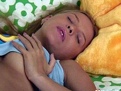 Jaw dropping blond hussy rubs her big juicy tits with hands before she lies on her back to tickle a shaved pinkish vagina in steamy solo sex video by Club Seventeen.
