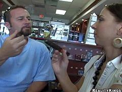 Busty and handsome milf in white shirt and black skirt gets seduced by a hunky charming dude in a cigarette shop and gets caught on camera with him