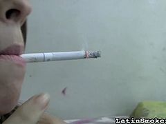 Smoking while posing her sexy forms only makes her horny and eager for action