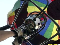 A reporter for a sex show comes along and sees a cute young couple near the beach. She asks about the places they have had sex and suggests they try to do it in a hot air ballon. The group heads to the ballon and they are taken high up in the sky where the blonde sucks on her boyfriend's hard dick.