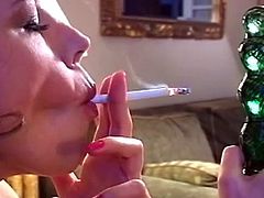 Brunette slut loves pushing her glass toy deep while smoking and moaning