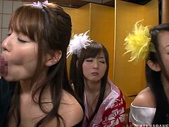 Pretty Japanese girls wearing kimonos are having fun with two dudes. The hotties kneel in front of the men and drive them crazy with wonderful blowjobs.