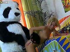 Teen blonde girl Sally is giving hot blowjob to her boyfriend that is dressed up in panda bear suit and fucks him.