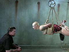 Kinky tattooed chick Sparky Sin Claire gets bound and hung up by some man in a basement. The dude tortures the slut and then plays with her nice shaved pussy.