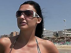Black haired Aletta Ocean with big fake hooters and firm bums in camo bikini gets filmed in point of view while having fun on the beach and flashing her tits.