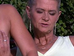 Watch a provocative granny seducing and dildoing her son's lovely teen girlfriend in the garden.