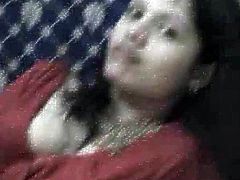 Brunette woman is indescribably seductive. She lies in front of cam wearing red traditional style dress. She caresses her sexy body revealing her privates.