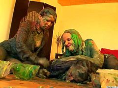 This kinky cat fight scene in fucked up for sure. Three smoking hot Euro chicks get wild with paints. Bitches struggle right on the floor all covered with brown and green paint.