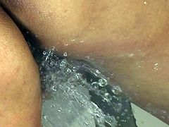 Hot tempered Japanese slut sits in the shower with legs spread aside rubbing her brownish vagina with fingers and tickling it with a water stream.