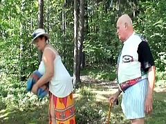 This grandpa and grandma are having a nice picnic in the woods. They take a break from eating sandwiches to fucks each other. The old lady sucks the old man's cock in the outdoors. Suddenly, she is caught by a hiker who watches the rest of the show unfold.