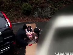 Nachi Kurosawa and two creepy men have sex in the middle of the street. They find a vacant parking lot and take out a cardboard box to hide their activities. She gets fingered and then is fuck against the rail around a garden.