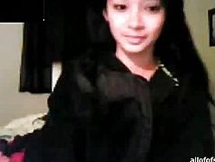 Girl in a black T-shirt sits before webcam