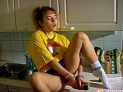 This gal in loose yellow T-shirt gets tired of washing the dishes. Palatable cutie with sweet tits and nice rounded butt spreads legs on the kitchen counter and starts polishing her wet pussy with a pink dildo right away.
