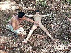 This dude gets tied up and blindfolded right in a forest in the forest. Then he gets his ass toyed and dick fondled.