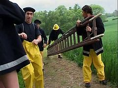 These four firemen get rewarded by two teens for the great job they've done. They are tongue kissing.