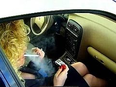 While smoking in the car, blonde milf gets horny to masturbate her twat