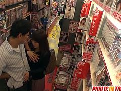 Check a naughty Japanese milf devouring her man's dong in the dvd store in this hot public sex video.