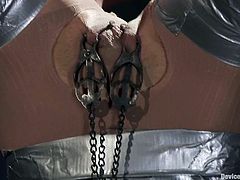 This BDSM scene is full of fetish and nasty things. Honey gets tapped all over and suspended upside down. Then her master puts her in the device and waxes her feet!
