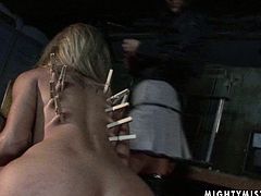 This alluring blonde needs to be punished hard. Cruel mistress puts her skills to the test giving every kind of sex tortures to this slut. She clamps clothespins on her slave's back in this awesome BDSM scene.