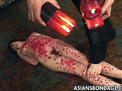 This Asian whore is tied up like the dirty slut that she is. Her master is going to punish her with hot candle wax. He drips the red candle wax on her tits, stomach and legs. She writhes in pain as the hot wax hits her body and hardens on her skin.