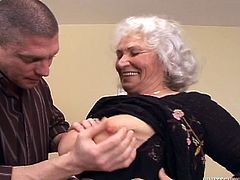 Slutty grandma Marinoka is mad for young cock. Than younger and harder, the better! She's fucking happy because she knows, she will get fucked by this dude. The guy grabs her soft saggy tits, licks them and then, she kneels to suck him hard. The experienced whore knows how to greet a cock with her lips!
