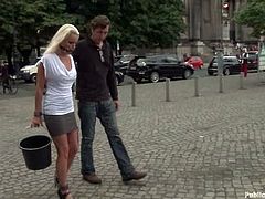 Stunning girl from Europe walks in the street with a gag in her mouth. Then she sucks a cock and gets fucked on the steps.