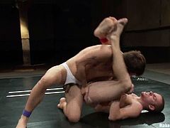 Jake Austin and Sebastian Keys are having a scuffle on tatami. They beat each other crazily and then have amazing gay doggy style sex.