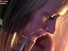 Watch this sexy blonde babe drinking wine while watching porn site on her laptop.She gets turns on and than she start to dance while stripping her clothes off.