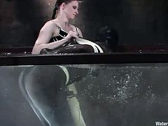Completely dressed in a nylon costume and tied up, this bitch is being drowned and fucked in a water tank, by mistress Vendeta. She loves to have such an obedient, defenseless sex slave on her hands. Vendeta drills her sex slave's pussy with a dildo and plays with her, the way she likes it
