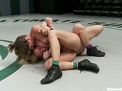 Kinky Darling and hot Ariel X fight in a ring. Later on they have passionate lesbian sex. The blonde chick gets her vagina stuffed with the strap-on.