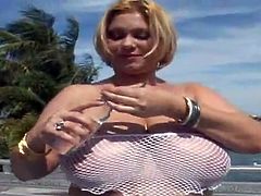 Salacious mature blonde Samantha 38G is having fun with some guy indoors. She oils her enormous tits and demonstrates them to the man and then gets her coochie pounded from behind.