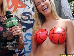 Now those are some basket balls that every guy will love to play with regardless the fact if he likes basketball or not! First he get so see this hot blonde with her boobs painted as balls and then our sexy blonde reporter goes further, seeking for other sluts in need of some cash!