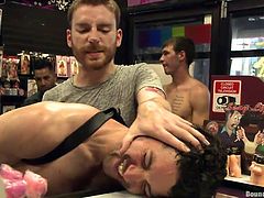 This guy stepped in a sex store, to find a sex toy for sexual satisfaction, but he found a lot more, than sex toys inside it. A few horny gay males, were waiting for such a cutie and soon, he ended up naked and ass fucked. The guys tied his hands, bent him over and fingered his asshole, before brutally fucking him