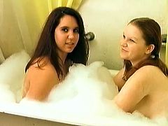 Brunette girls take bubble bath together. Then they go to the bedroom and toy each others pussies lying on a bed.