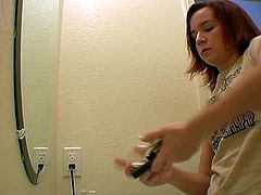 Adorable redhead cutie gets filmed in the bathroom. Enjoy watching her brush her pretty face before putting on her slutty make up.