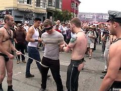 Check this homosexuals dressed up as sadomasochists acting dirty in the middle of the street while people watch them very surprised!