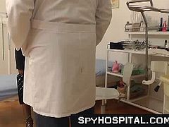 Someone has hidden a spy cam inside this doctor's office. It has recorded a really intimate consultation. The doctor is inserting a speculum in his patient's vagina.