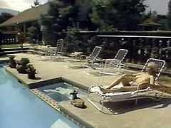 Lovely blonde milfie with big natural tits and huge butt takes sunbath totally naked. One cocky stud eats her meaty shaved pussy and fucks her missionary style over the poolside.