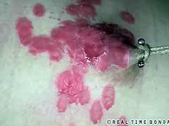 Mollie Rose has her mouth covered and her arms and legs tied up. Her nipples are sore because of the nipple clamps and the hot wax poured all over them. She's tortured to tears.