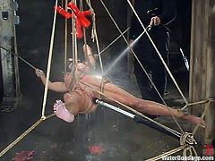 Tied and hanged Wenona experiences only the extremes. She has wax all over her body and the executor pours some more hot wax on her and then dildo fucks her pussy and cleans her with water. The cold water jet and that hot was really gives this whore some nice sensations