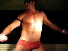 A guy has filmed a real stripper dancing on stage. He is smoking hot and good at what he does. He has a muscular body and an impressive bulge in his boxers.