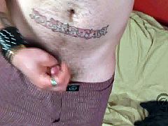 A tattooed gay is playing with his schlong indoors. He strokes and rubs the dick ardently and moans with pleasure when it explodes with cum on his navel.