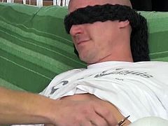 This bald guy thinks he's going to fuck a hot blonde, but she puts a blindfold on his eyes and he doesn't notice when a guy sucks on his pole. He ends up riding that guy's cock.